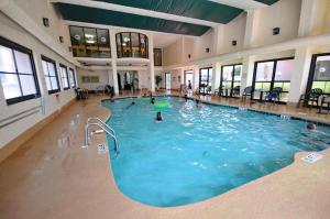 a large swimming pool in a building with people in it at Ocean Front 53 Steps in Myrtle Beach