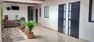 a hallway with doors and potted plants in a building at Daresff Imperial in Puerto Wilches