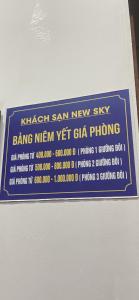 a sign on a wall that says bang new new vet clga phone at New Sky Hotel in Dong Quan