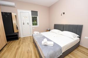 a bedroom with a large bed with white pillows at Mezani Guest House in Vlorë