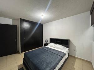 a bedroom with a large bed in a room at Departamento Lumina Sipeh Xalapa in Xalapa +21 photos