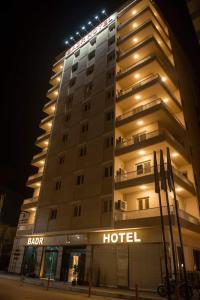 a hotel building with a hotel sign in front of it at Badr Hotel Assiut in Asyut