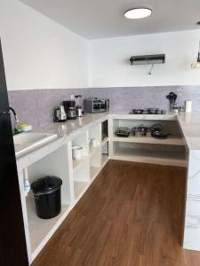 a kitchen with a sink and a counter top at Modern Apartment close to the airport in Lima