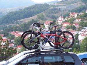 two bikes on the roof of a car at Valia Calda Hotel in Perivoli