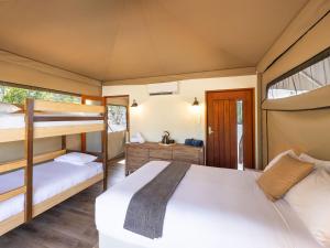 a bedroom with two bunk beds and a bathroom at Paradise Country Farmstay in Gold Coast