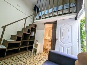 a room with a loft bed and a staircase at Hostel El Español in Santo Domingo