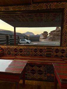 a room with a view of a car in the desert at Full moon camp in Disah