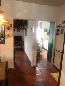 a room with a hallway with a room with a kitchen at Apto charme frente para a praia in Itanhaém +6 photos