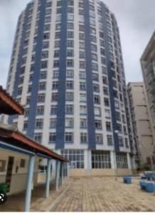 a large blue and white building in a city at Apto charme frente para a praia in Itanhaém