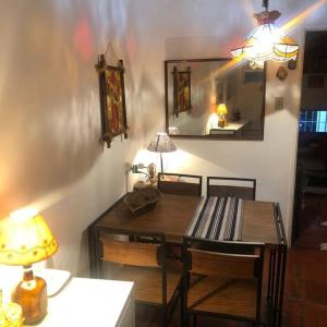 a dining room with a table and a mirror at Apto charme frente para a praia in Itanhaém