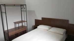 a bedroom with a white bed with a wooden headboard at Vista da Serra in Cavalcante