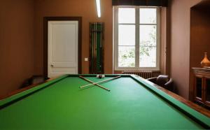 a pool table in a living room with avertisement at Villa Persienne in Cannes