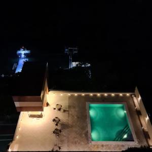 a view of a building with a swimming pool at night at Flat Sol Victoria Marina Vista Mar in Salvador