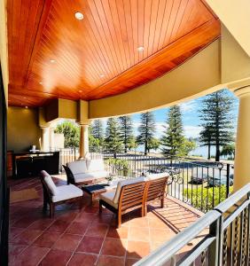 une terrasse couverte avec des chaises et un balcon avec vue dans l'établissement 59 Lakeside Luxury Views 2br 2baparking, à Perth