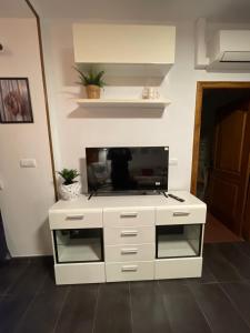 a white cabinet with a tv on top of it at Casa Pancho.Casita acogedora en Valencia in Valencia