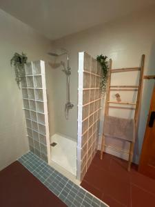 a bathroom with a shower with glass doors and a tile floor at Casa Pancho.Casita acogedora en Valencia in Valencia