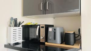 a kitchen counter with several appliances on a counter top at Impeccable 1 Bedroom Flat in Central London in London