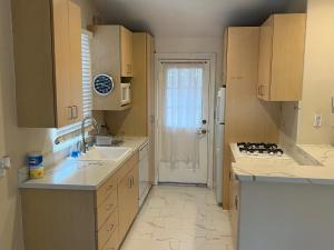 a small kitchen with a sink and a stove at 2bedroom & 1bath home near Universal Studio & Hollywood in Van Nuys