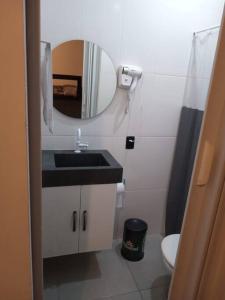 a small bathroom with a sink and a mirror at casa com bela vista em itatiba in Bragança Paulista