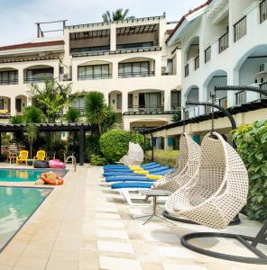ボラカイにあるル ソレイユ ドゥ ボラカイ ホテルのホテルの隣にスイミングプールと椅子があります。