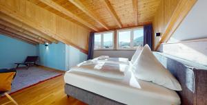 a large bed in a room with a large window at WeitsichtLodge in Garmisch-Partenkirchen +28 photos