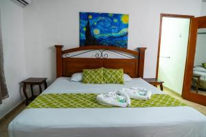 a bedroom with a bed with two towels on it at Suites & Apartments San Benito - Zona Rosa in San Salvador