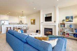 a living room with a blue couch and a fireplace at Whaler's Point in Seaside