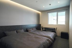 a bedroom with a large bed and a window at NEW HUMBER 