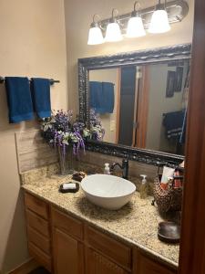 a bathroom with a sink and a large mirror at And Boots Start Knocking in Stillwater