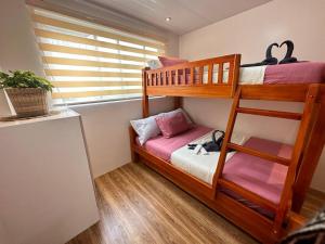 a bedroom with two bunk beds and a window at Yllib Transient Condo in Baguio