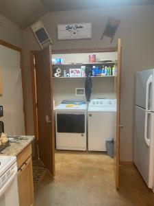 a kitchen with a white stove and a refrigerator at And Boots Start Knocking in Stillwater