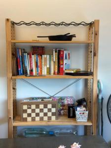 a book shelf filled with books and a chess board at Tranquil Graniteville Hideaway- Greater CSRA Area in Aiken