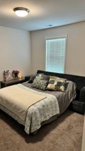 a bedroom with a bed and a chair and a window at Tranquil Graniteville Hideaway- Greater CSRA Area in Aiken