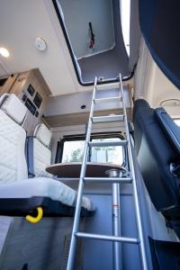 a ladder in the interior of an rv at Van Del Sol - Stay where it moves you with Sunny in San Juan