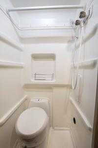 a small bathroom with a toilet in a boat at Van Del Sol - Stay where it moves you with Sunny in San Juan