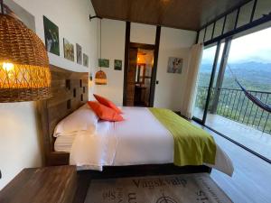 a bedroom with a bed and a large window at Natubri Ecohotel Habitacion VIP in San Francisco