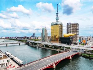 a bridge over a river in a city with buildings at MIMARU Tokyo Asakusa Station in Tokyo