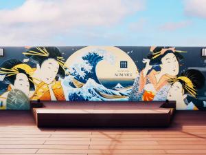 a wall with a mural of a wave on it at MIMARU TOKYO ASAKUSA STATION in Tokyo