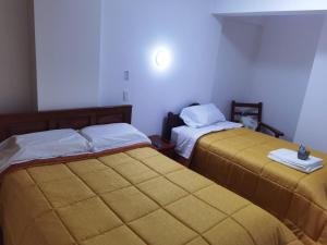 a room with two beds in a room at LOS NEVADOS II in Huaraz