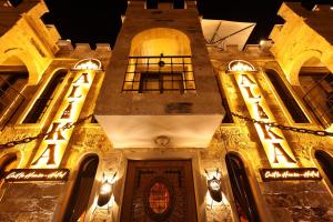 an old building with lights on it at night at Alika Castle House in Uchisar