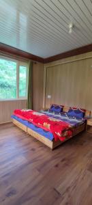 a bedroom with a large bed in a room at beheney Homestay gondhla in Kyelang +12 photos