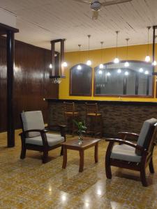 a living room with two chairs and a table at Hotel Sansivar in El Venado