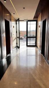 an empty hallway of an office building with glass doors at شقة خاصة فاخرة + صالة بلياردو in Riyadh