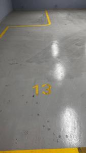 a yellow number on the floor of a parking lot at شقة خاصة فاخرة + صالة بلياردو in Riyadh