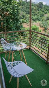 a patio with a table and chairs on a balcony at UCM Adventure Park in San Mateo +6 photos