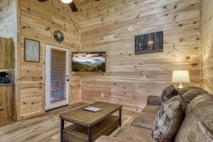 ein Wohnzimmer mit Sofa und Tisch in der Unterkunft Kitt's Cottage, Pickleball Court, Creek, WIFI, Mountain Views, Starting at 79" in Cosby