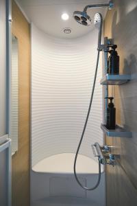 a bathroom with a shower with a blow dryer at NEW HUMBER 