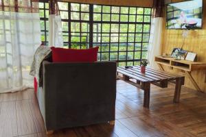 a living room with a couch and a table at Nairobi Karen Tree House in Nairobi