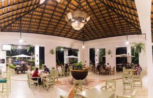 a restaurant with tables and people sitting at tables at Hotel Kopal in Lanquín