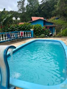 a swimming pool with a water fountain at Casa Sítio Beija Flor in Guaramiranga